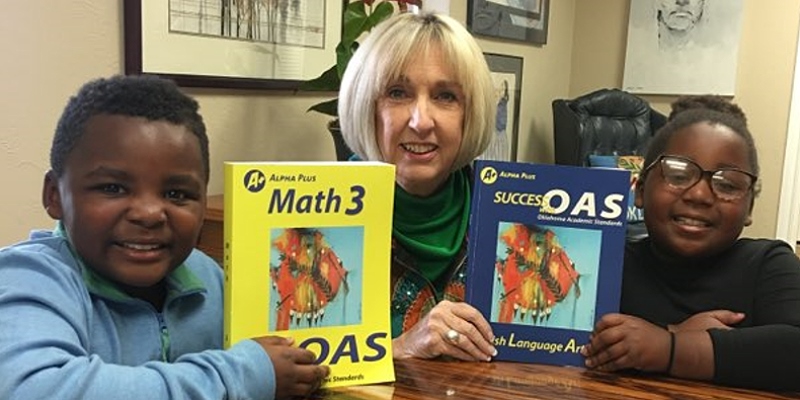 Alpha Plus CEO Jan Barrick with Students and the Success with OAS books